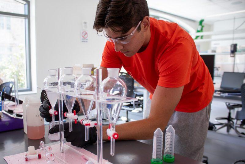 A student taking measurements inside a lab.